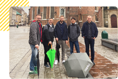 Caspio team photo with umbrellas