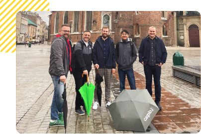 Caspio team photo with umbrellas
